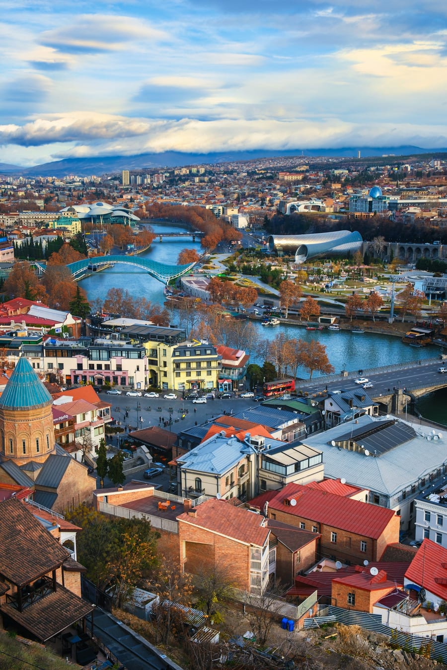 Aerial view of Tbilisi, Georgia — the Bridge of Peace and Mtkvari River at the heart of the old city